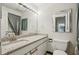 Bathroom features a light granite countertop, large vanity mirror, and tiled floors at 1130 Piedmont Ne Ave # 402, Atlanta, GA 30309