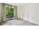 Bedroom with beige carpet and neutral colored curtains over glass doors to outdoor patio area at 1130 Piedmont Ne Ave # 402, Atlanta, GA 30309