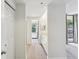 Bright hallway leading to bathroom with neutral carpet and white trim and doors at 1130 Piedmont Ne Ave # 402, Atlanta, GA 30309
