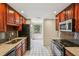 Kitchen features dark wood cabinetry, stainless steel appliances, and a window with natural light at 1130 Piedmont Ne Ave # 402, Atlanta, GA 30309