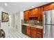 This kitchen features dark wood cabinets, stainless steel appliances, and a tiled floor at 1130 Piedmont Ne Ave # 402, Atlanta, GA 30309