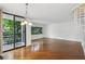 Spacious living room with hardwood floors, spiral staircase, and sliding glass doors leading to a balcony at 1130 Piedmont Ne Ave # 402, Atlanta, GA 30309