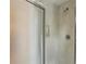 Shower with frosted glass door and marble-patterned walls, shower head, and built-in shelf at 1130 Piedmont Ne Ave # 402, Atlanta, GA 30309