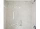Shower with marble patterned walls, shower head and controls, and a built-in soap shelf at 1130 Piedmont Ne Ave # 402, Atlanta, GA 30309
