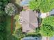 Aerial view of a home with a well-manicured lawn, patio, and surrounding trees at 1450 Liberty Ln, Cumming, GA 30040