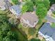 Aerial view of a neighborhood featuring homes with well-maintained lawns and mature trees at 1450 Liberty Ln, Cumming, GA 30040