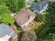 Aerial view of a home and its backyard with a patio set, surrounded by lush greenery and neighboring houses at 1450 Liberty Ln, Cumming, GA 30040