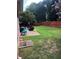 Lush backyard with green grass, a patio area, and playset, ideal for outdoor activities at 1450 Liberty Ln, Cumming, GA 30040