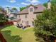 A spacious backyard featuring a well-maintained lawn and a patio with outdoor seating at 1450 Liberty Ln, Cumming, GA 30040