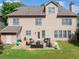 Large backyard with patio, outdoor furniture, and a grassy area, perfect for entertaining at 1450 Liberty Ln, Cumming, GA 30040