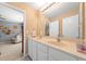 Bathroom featuring double sinks, a large mirror, and access to a connected room, providing ample space at 1450 Liberty Ln, Cumming, GA 30040