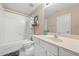 Neat bathroom featuring a bathtub with shower, a white vanity, and a framed mirror for a clean and organized feel at 1450 Liberty Ln, Cumming, GA 30040