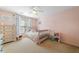 Cozy pink bedroom with a single bed, complemented by natural light and soft furnishings for a comforting atmosphere at 1450 Liberty Ln, Cumming, GA 30040