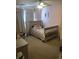 Bright bedroom features a ceiling fan, neutral carpet, and a cozy bed with floral bedding at 1450 Liberty Ln, Cumming, GA 30040