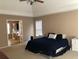 Spacious bedroom features a tray ceiling, cozy furnishings, and an open doorway to the en-suite bathroom at 1450 Liberty Ln, Cumming, GA 30040