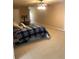 Expansive bedroom featuring neutral walls, plush carpeting, and a bed with a blue plaid comforter at 1450 Liberty Ln, Cumming, GA 30040