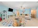 Spacious bonus room with TV, a comfortable seating area, and a play area with a table and shelving at 1450 Liberty Ln, Cumming, GA 30040