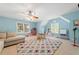 Versatile bonus room featuring a plush sofa, play area and a view of the outdoors through bright windows at 1450 Liberty Ln, Cumming, GA 30040