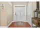 Bright entryway with hardwood floors, a white front door with sidelights, and an adjacent closet at 1450 Liberty Ln, Cumming, GA 30040