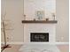 Elegant fireplace with a white stone surround and a rustic wood mantle at 1450 Liberty Ln, Cumming, GA 30040