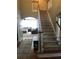 Inviting foyer with staircase, hardwood floors and open access to the cozy living room at 1450 Liberty Ln, Cumming, GA 30040