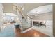 Grand foyer with staircase, hardwood floors, and open view to the dining and living areas at 1450 Liberty Ln, Cumming, GA 30040