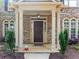 Inviting front porch with classic columns and decorative planters leading to a charming entrance at 1450 Liberty Ln, Cumming, GA 30040