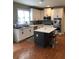 Modern kitchen with white cabinets, stainless steel appliances, and a stylish dark island at 1450 Liberty Ln, Cumming, GA 30040