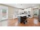 Modern kitchen with stainless steel appliances, a kitchen island with seating, and bright white cabinets at 1450 Liberty Ln, Cumming, GA 30040