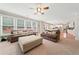 Bright living room showcasing sofas, a large ottoman, and natural light with an open floor plan leading to the kitchen at 1450 Liberty Ln, Cumming, GA 30040