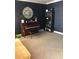 Stylish living room with dark blue walls, a piano and a modern bookcase at 1450 Liberty Ln, Cumming, GA 30040