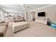 Open-concept living room with kitchen view, plush seating, and a large area rug at 1450 Liberty Ln, Cumming, GA 30040