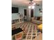 Spacious living room with a large rug, comfortable seating, and an entertainment area with a TV at 1450 Liberty Ln, Cumming, GA 30040