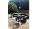Inviting patio with comfortable outdoor seating, a basketball hoop, and a well-maintained backyard at 1450 Liberty Ln, Cumming, GA 30040