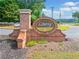 A brick entrance sign for Liberty featuring an oval sign with the community name at 1450 Liberty Ln, Cumming, GA 30040