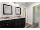 Bathroom featuring a dual sink vanity with granite countertop and modern fixtures at 1749 W Caribaea Se Trl, Atlanta, GA 30316