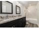 Bathroom featuring a dual sink vanity with granite countertop and modern fixtures at 1749 W Caribaea Se Trl, Atlanta, GA 30316