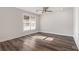 Sun-drenched bedroom features modern flooring, a ceiling fan, and plenty of light at 1749 W Caribaea Se Trl, Atlanta, GA 30316