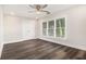 Bright bedroom featuring sleek flooring, ceiling fan, and lots of natural light at 1749 W Caribaea Se Trl, Atlanta, GA 30316
