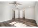 Bright bedroom with sleek gray-toned flooring, ceiling fan, and easy access to other rooms at 1749 W Caribaea Se Trl, Atlanta, GA 30316