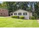 A charming single-story house with a well-kept lawn and an adjacent brick building at 1749 W Caribaea Se Trl, Atlanta, GA 30316