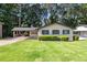 Charming single-story home with a well-manicured lawn and attached carport at 1749 W Caribaea Se Trl, Atlanta, GA 30316
