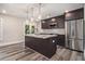 Open kitchen featuring a center island, stainless appliances, granite countertops, and modern finishes at 1749 W Caribaea Se Trl, Atlanta, GA 30316
