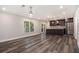 Open-concept living room and kitchen with stainless steel appliances and wood flooring at 1749 W Caribaea Se Trl, Atlanta, GA 30316