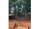 Backyard with wooden deck, mature trees, and fenced perimeter, offering a private and peaceful outdoor space at 222 Yardsley Dr, Mcdonough, GA 30253
