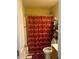 Bathroom space with snowflake-themed shower curtain, toilet and shelves at 222 Yardsley Dr, Mcdonough, GA 30253