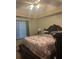 Cozy bedroom featuring a ceiling fan and a comfortable-looking bed with decorative pillows and an ornate headboard at 222 Yardsley Dr, Mcdonough, GA 30253