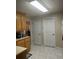 Functional kitchen space featuring tiled floors, white painted doors, and ample storage cabinets at 222 Yardsley Dr, Mcdonough, GA 30253
