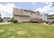 Spacious backyard with a well-maintained lawn, patio, and deck, great for outdoor entertaining at 3574 Timberloch Trl, Snellville, GA 30039