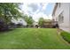 Expansive backyard with lush lawn, mature trees, and a wooden deck for outdoor enjoyment at 3574 Timberloch Trl, Snellville, GA 30039